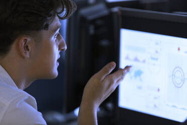 Focused junior high boy student using computer in computer lab - CAIF25720