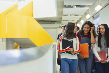 Junior high girl students walking in corridor - CAIF25731