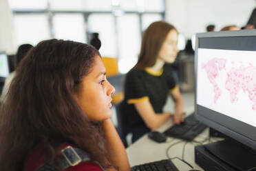 Focused junior high girl student using computer in computer lab - CAIF25752