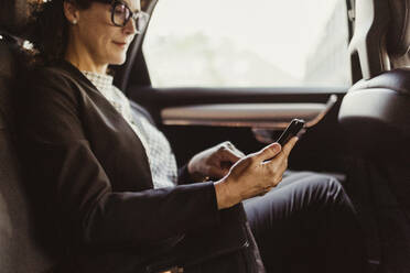 Entrepreneur using mobile phone while sitting in car - MASF17615