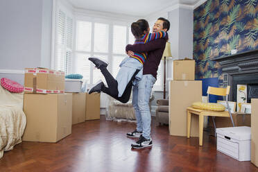 Happy excited couple moving into new apartment - CAIF25936