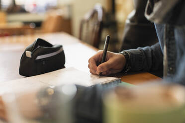 Young male college student studying in cafe - CAIF26066