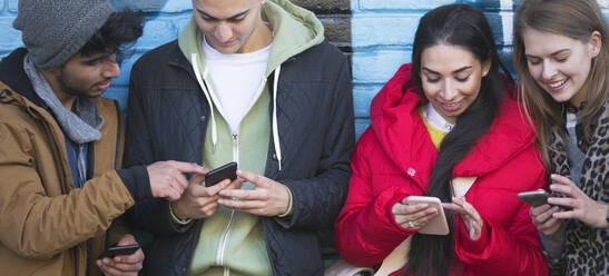 Young adult friends using smart phones - CAIF26151