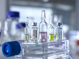 Close-up of various pharmaceutical vials standing in laboratory - ABRF00718