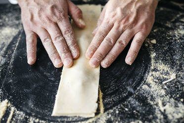 Close-up of man preparing homemade gluten free pasta - JRFF04312