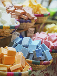 Morocco, Baskets of colorful soaps sold at market - VEGF01867