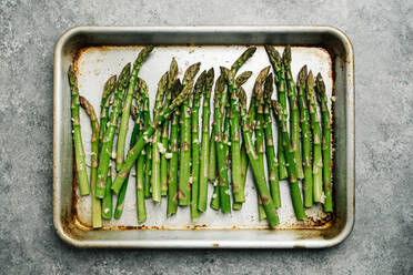 Oiled asparagus on a baking sheet - CAVF78141