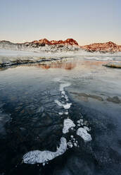 Coastline with ice and snow against mountains - CAVF78342