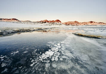 Coastline with ice and snow against rocks in winter - CAVF78343