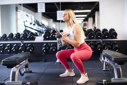 Eine Frau trainiert im Fitnessstudio. - CAVF78382