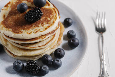 Stack of pancakes with berries on top - CAVF78557