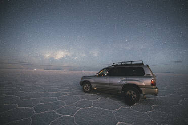 Car under the stars in Uyuni salar - CAVF78653