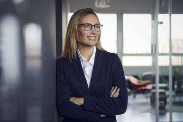 Portrait of smiling businesswoman in office - RBF07506