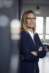 Portrait of smiling businesswoman in office - RBF07508