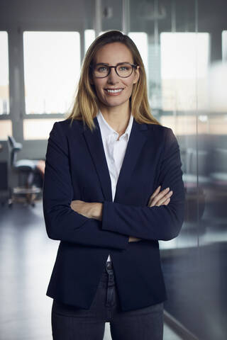 Portrait of smiling businesswoman in office stock photo