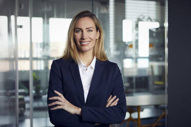 Portrait of smiling businesswoman in office - RBF07514