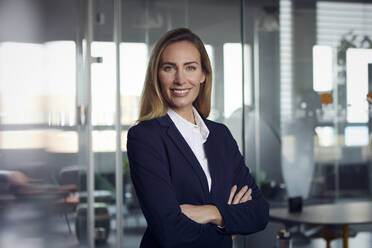 Portrait of smiling businesswoman in office - RBF07515