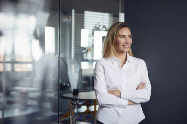 Portrait of smiling businesswoman in office - RBF07522