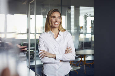 Portrait of smiling businesswoman in office - RBF07523