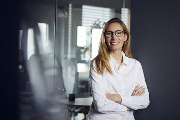 Portrait of smiling businesswoman in office - RBF07526