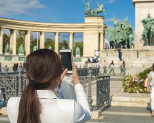 Asian tourist take photo with phone from the Millennium monument - CAVF78739