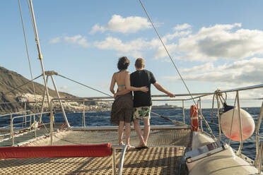 Couple hugging on a boat in the atlantic ocean by Tenerife - CAVF78759