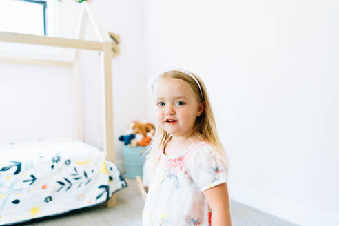 Closeup portrait of a young girl in her modern bedroom - CAVF78852