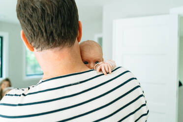 Cropped portrait of a dad holding his baby over his shoulder - CAVF78900