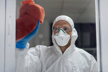 Cleaning staff desinfecting hospital against contageous virus, wearing protective clothing - CJMF00293