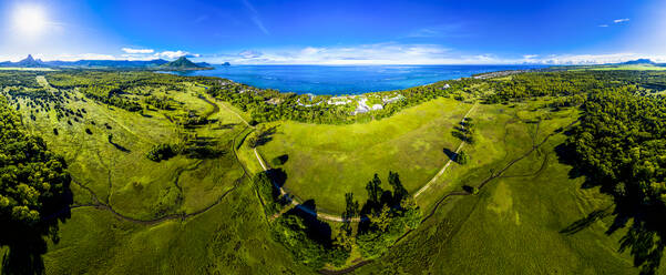 Mauritius, Black River, Flic-en-Flac, Aerial view of sun shining over green coastal landscape in summer - AMF07979