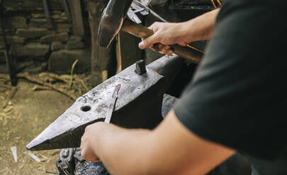 Blacksmith at work in his workshop - DGOF00806