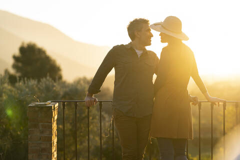 Couple enjoying the view of the sunset in the countryside, Orgiva, Andalusia, Spain stock photo