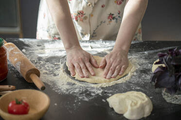 Woman's hands kneeling dough on worktop - VPIF02248