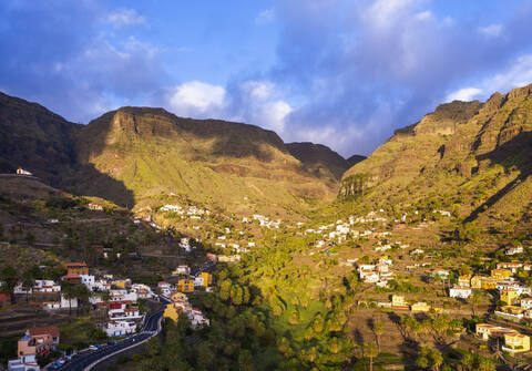 Spain, Santa Cruz de Tenerife, Valle Gran Rey, Aerial view of village in mountain valley at dusk stock photo