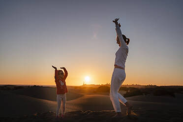 Happy mother and daughter in sand dunes at sunset, Gran Canaria, Spain - DIGF09544