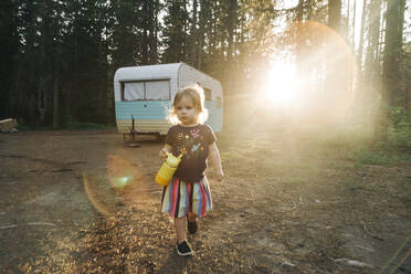 Ein Kind spaziert bei Sonnenuntergang auf einem Campingplatz in der Nähe von Mt. Hood, Oregon. - CAVF78995