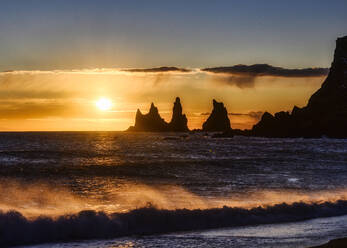 Iceland, Silhouettes of Reynisdrangar sea stacks at moody sunset - TOVF00156