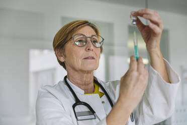 Doctor preparing a vaccine for patient - MFF05485