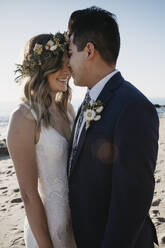 Happy bridal couple at the beach - LHPF01237