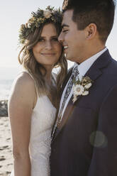 Happy bridal couple at the beach - LHPF01238