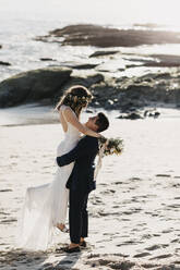 Happy bridal couple at the beach - LHPF01247