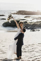 Happy bridal couple at the beach - LHPF01248