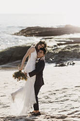 Happy bridal couple at the beach - LHPF01249