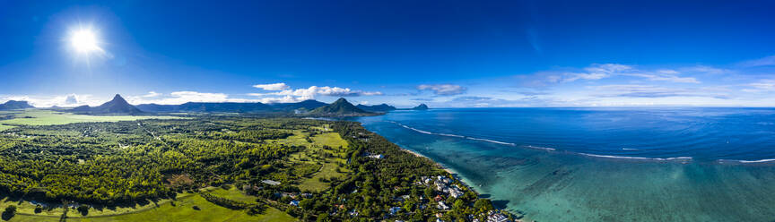 Mauritius, Black River, Flic-en-Flac, Helicopter panorama of sun shining over Indian Ocean and coastal village - AMF07988