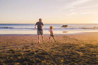 Father and son playing and running on the beach - IHF00326