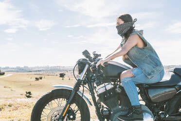 Young beautiful woman riding motorbike - DAMF00328