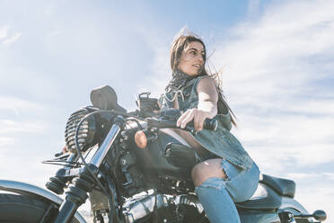 Young beautiful woman riding motorbike - DAMF00331