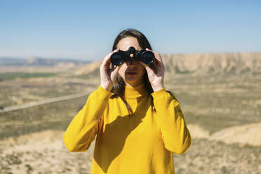 Portrait of a woman with binoculars, Bardenas Reales, Arguedas, Navarra, Spain - XLGF00011
