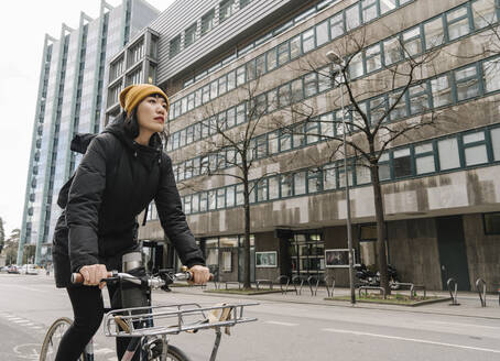 Frau fährt Fahrrad in der Stadt, Frankfurt, Deutschland - AHSF02220