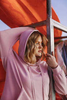Portrait of young blond woman wearing pink hoodie sweater - AGGF00016